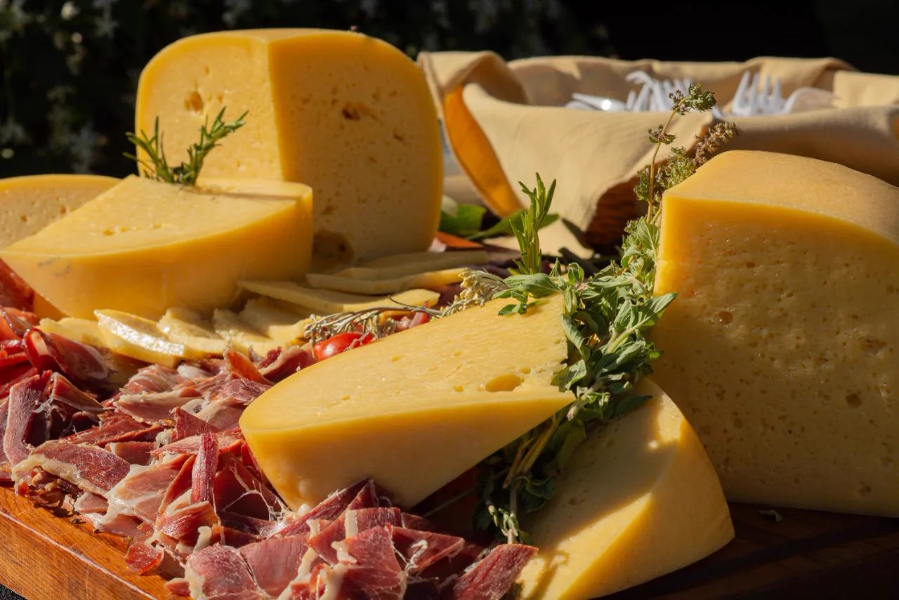 Tabla de quesos y jamón crudo con hierbas frescas del catering de Las Cortaderas