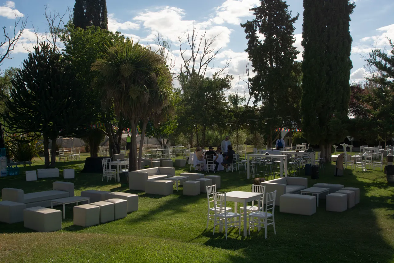 Livings y puffs distribuidos en el parque para un evento al aire libre