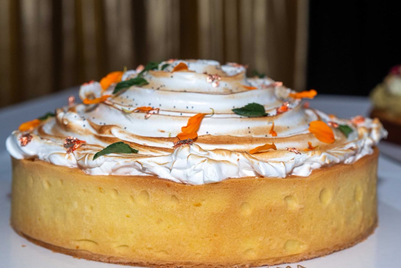 Torta de merengue y limón decorada con flores comestibles